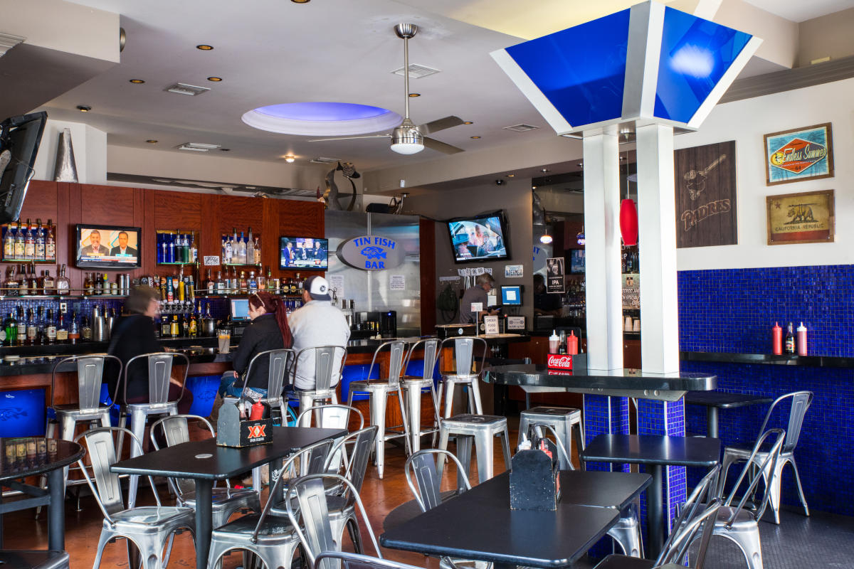 Resaturant interior, tables lined up, bar area in the garden